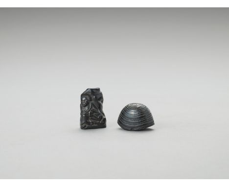 TWO EBONY WOOD NETSUKEUnsignedJapan, 19th centuryOne carved as a pilgrim's hat with a himotoshi bar to the underside, the oth