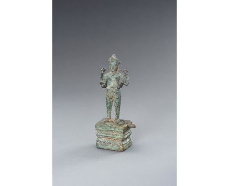 A KHMER BRONZE FIGURE OF VISHNU, ANGKOR PERIODKhmer Empire, 12th - 13th century. The deity standing in samapada on a yoni, hi