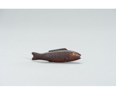 A LARGE WOOD FISH NETSUKEJapan, 19th centuryDepicting a swimming fish, the scales and fins finely carved, the eyes double inl