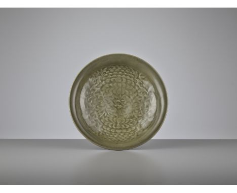 A YAOZHOU CELADON CARVED 'PEONY' SHALLOW BOWL, NOTHERN SONG DYNASTYChina, 960-1127. The interior deftly and deeply carved wit