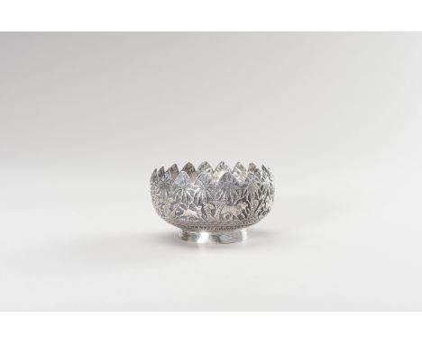 A SMALL THAI SILVER BOWLThailand, c. 1920. The charming silver bowl, portraying a jungle scene with various animals like bird