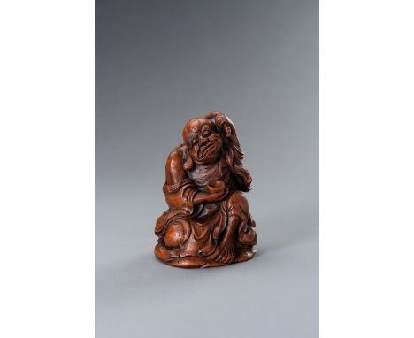 A BAMBOO FIGURE OF UNHAPPY LUCKY BUDDHAChina, Republic period (1912-1949). Seated on a rock, covered in a loose robe revealin