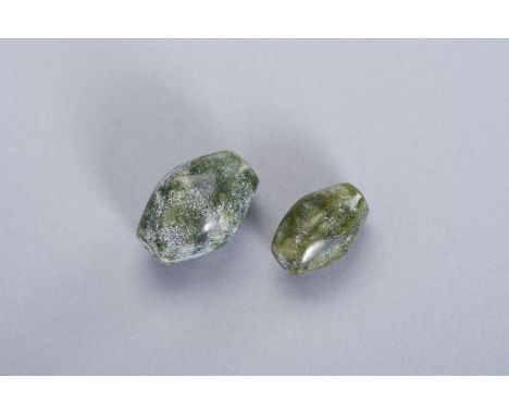 TWO FINE JADE BEADSChina, Qing dynasty (1644 - 1912) or earlier. Different in size, opaque and biconical in shape spinach jad