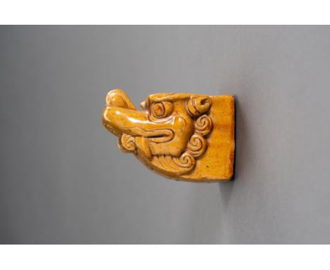 A GLAZED 'BUDDHIST LION' ARCHITECTURAL ELEMENTChina, Qing Dynasty (1644-1912). The ceramic piece shaped as the head of a Budd