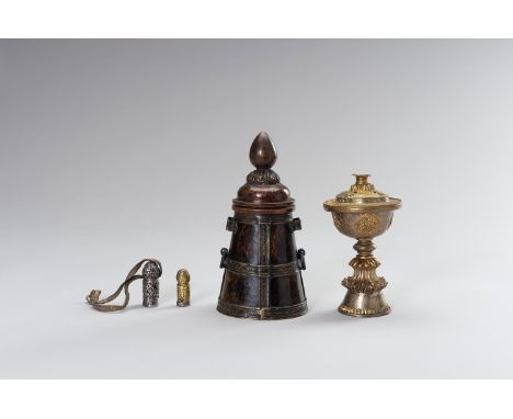 A GROUP OF TWO SEALS, A TSAMPA VESSEL AND A BUTTER LAMPTibet, 19th century. The lot comprising a cast iron seal and a brass a