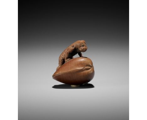 SUKETADA: A RARE WOOD NETSUKE OF A KAPPA ON A HAMAGURIBy Eguro Suketada, signed Suketada 亮忠Japan, Takayama, 19th century, Edo