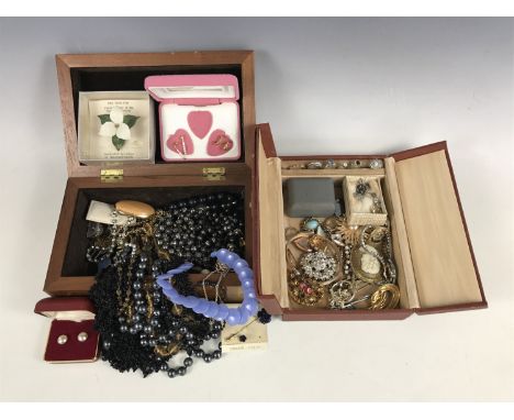 Two vintage jewellery boxes containing a quantity of assorted costume jewellery, including paste brooches, rings, necklaces a