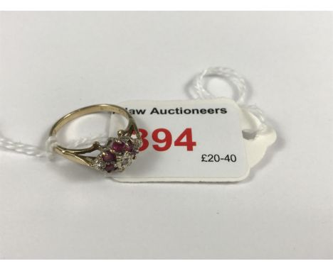 A vintage diamond and almandine garnet dress ring, the lenticular face claw set with a flower head cluster, above an open gal