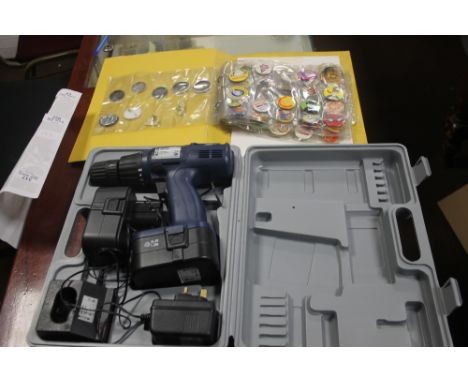A BUDGET ELECTRIC DRILL IN CASE TOGETHER WITH A FOLDER OF BUTTON BADGES