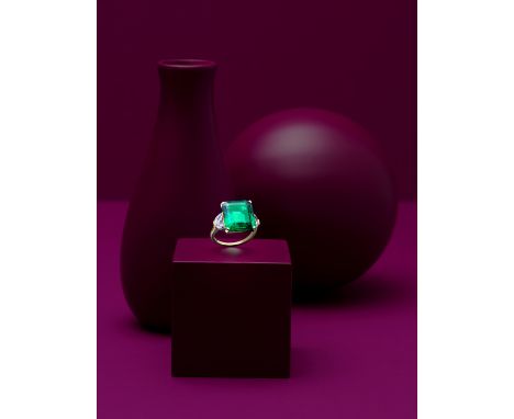 A FINE EMERALD AND DIAMOND RING, BY BULGARIThe step-cut emerald weighing 10.04 carats between demi-lune-shaped diamond should