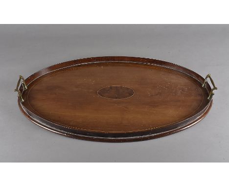 An Edwardian mahogany oval tray, having string inlay, raised gallery sides and twin brass handles, 63 cm x 41 cm, together wi