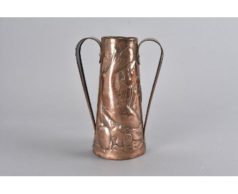 A Newlyn arts and crafts copper twin handled vase, of tapering design with loop strap handles, the body decorated with fish s