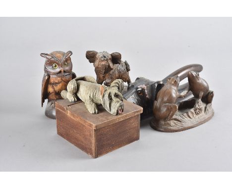 Five Black Forest carved novelty items, including a dog cigarette box, an owl inkwell, a carved wild boar, a pair of frogs sh