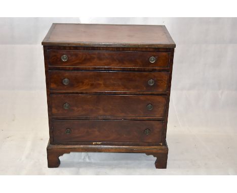 A small flame mahogany chest of four graduated long drawers, with ring handles on bracket feet, 80 cm x 45.5 cm x 87 cm high 