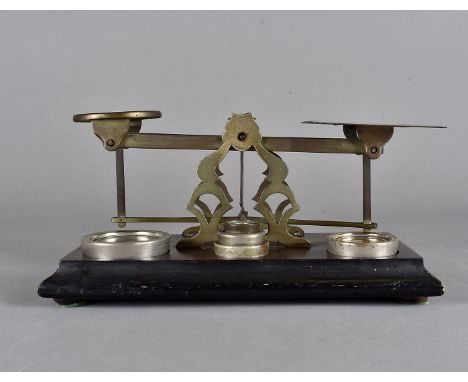 A Morden & Co set of scales, on coromandel base, with weights, 17 cm x 14 cm x 13 cm high 