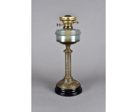 An Edwardian oil lamp, brass column support, blue glass reservoir, ornate frosted shade, all on a terracotta black glazed bas