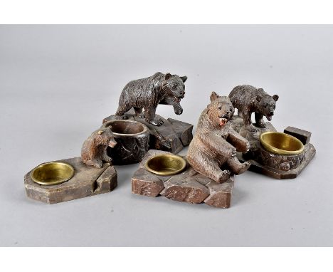 A collection of Black Forest carved bear mounted ashtrays and matchbox holders, some carved standing, others recumbent and se