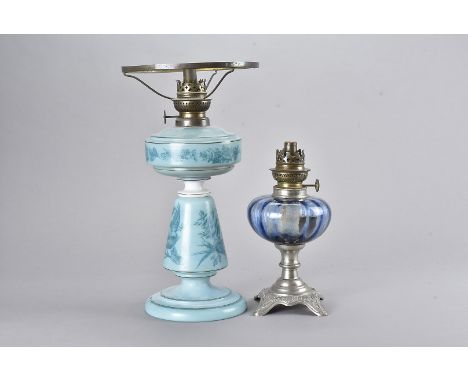 A Victorian opaque glass oil lamp, with transfer printed decoration of blackbird and snail on a turquoise ground with white g