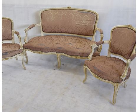 A Louis XV style salon suite, comprising sofa and two fauteuils, in white painted carved wooden frame heightened in gilt, sof