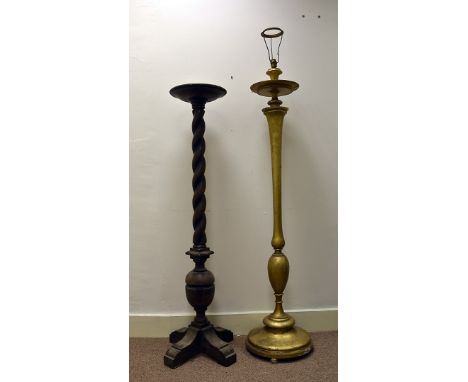 A gilt wood standard lamp, with ovoid and tapered stem 156 cm high, together with an oak barley twist torchere 141 cm high (2