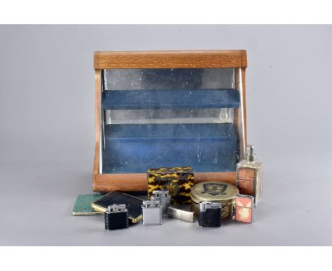 A mid-late 20th Century Ronson light shop display case, together with a selection of cigarette cases, lighters and other smok