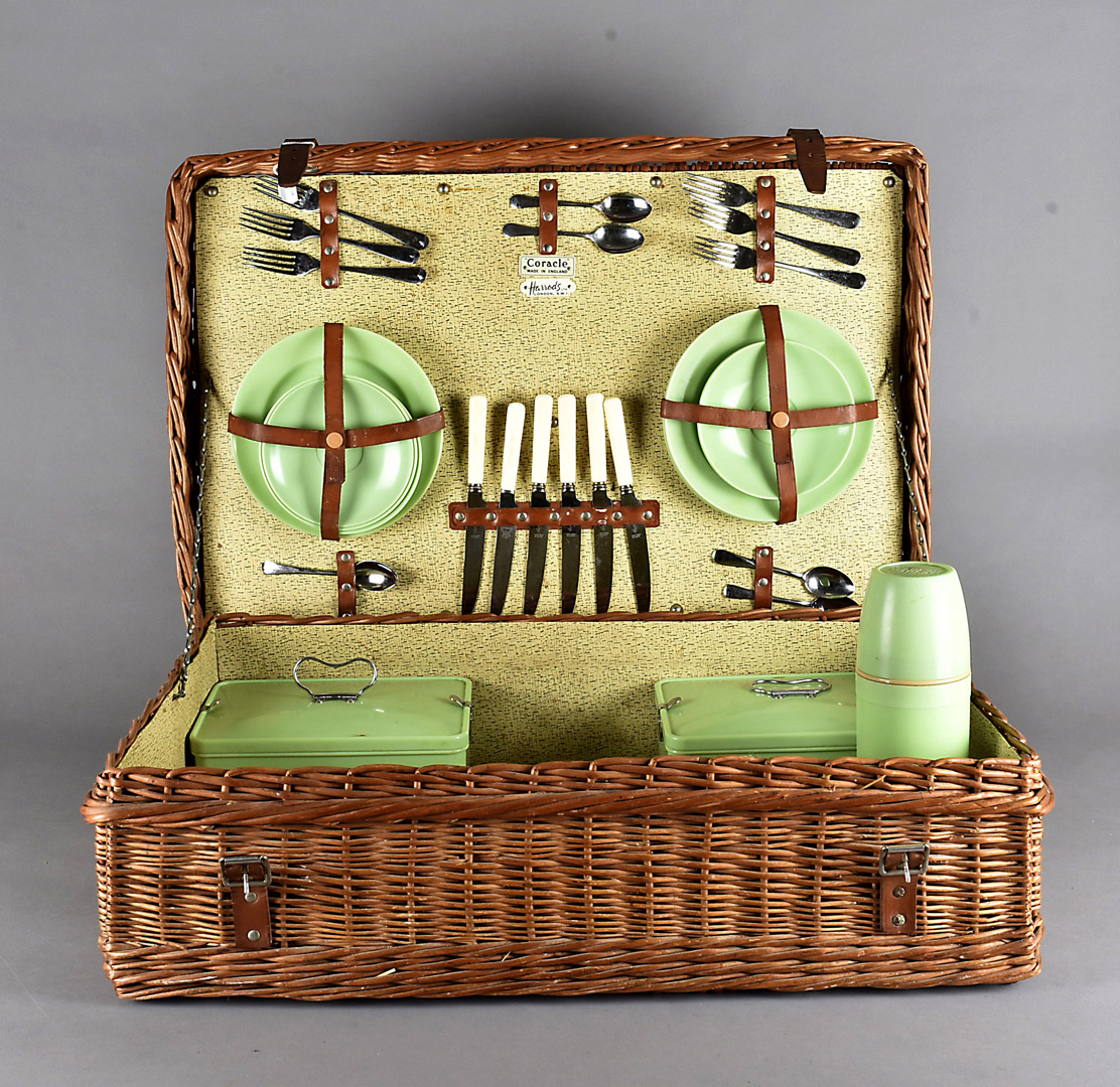 A Harrods Coracle picnic basket, the wicker basket with green plastic