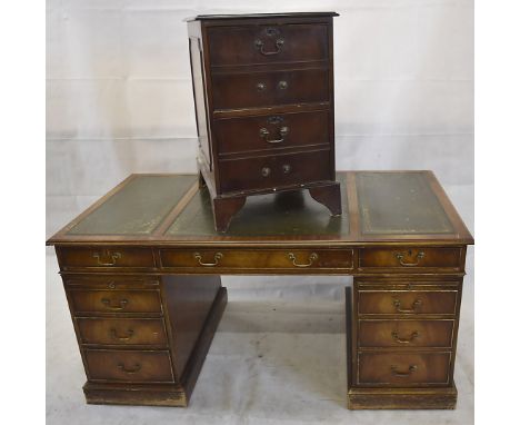 A reproduction twin pedestal desk, having three drawers over two banks of three drawers, with leather inset top, 157 cm x 87 