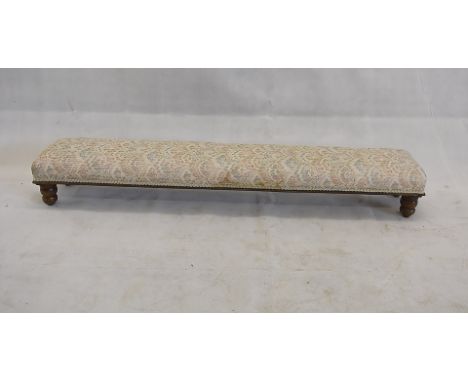 An Edwardian oak rectangular footstool, with floral stuffover cushion, on four turned supports, 133 cm x 23 cm 