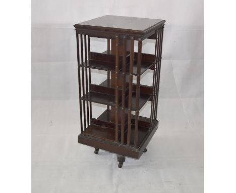 An Edwardian mahogany revolving bookcase, three tier with slatted sides, ceramic castors, 50 cm square x 110 cm high 