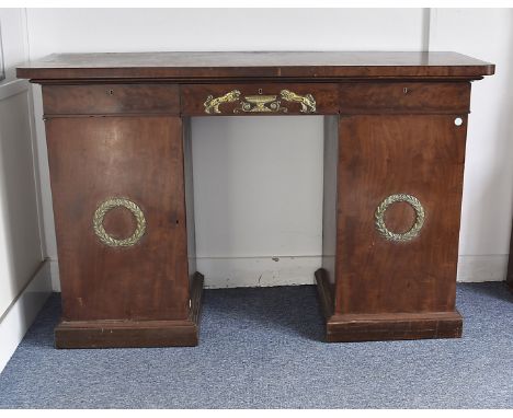A Regency mahogany veneered twin pedestal sideboard, fitted with three frieze drawers, central drawer with brass tigers and u
