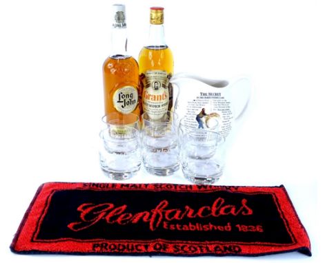 A bottle of Grants Standfast Scotch Whisky, a bottle of Long John Blended Scotch Whiskey, six tumblers, a Macallan jug, etc.