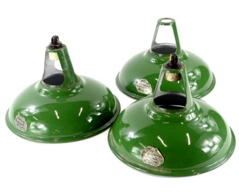 A set of three Coolicon green enamel industrial light shades, each with original labels, 28cm diameter.