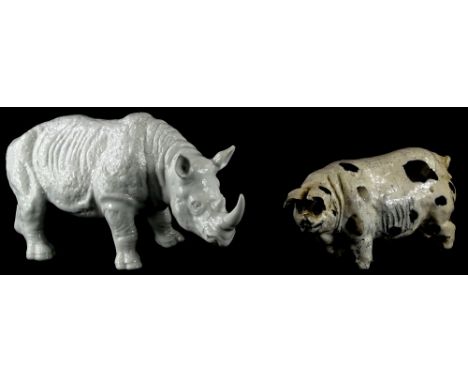 A porcelain model of a rhinoceros, 33cm long, and a studio ceramic pig, in distinct initials, BM, to underside.