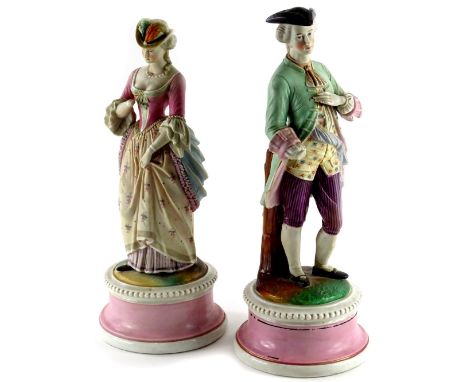 A pair of late 19thC continental bisque porcelain figures, modelled in the form of a gentleman and lady wearing brightly colo