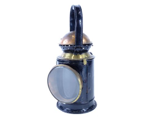 An ebonised metal and copper and brass Railway type lamp, with thick bevelled glass number plaque to side, 19518, 35cm high.