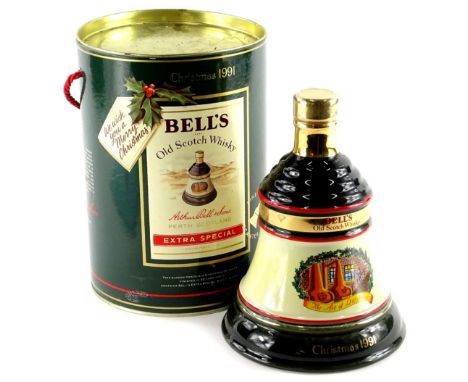 A bottle of Bells Christmas 1991 extra special whisky, in a bell shaped decanter, boxed.