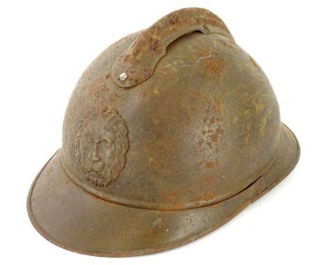 A First World War period Belgium Adrian helmet, traces of original paint, with simple strap, indistinct name crudely engraved