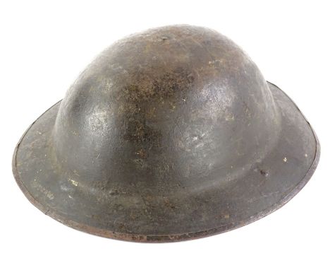 A WWI period B model Brodie metal helmet, indistinctly signed stamped, strap, 31.5cm x 21.5cm. 