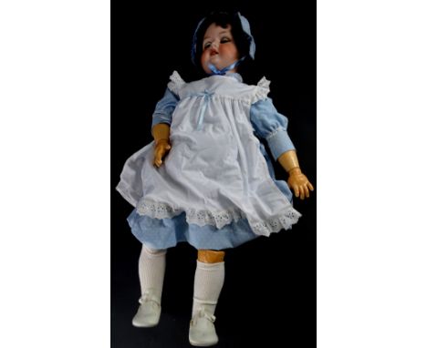 An Armand Marseille German bisque headed doll, numbered 390 and 14, with composition limbs, 74cm high overall.