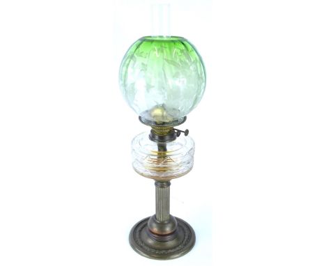 A Victorian brass oil lamp, with reeded column and leaf cast base, with a green globular etched floral shade, the mechanism A