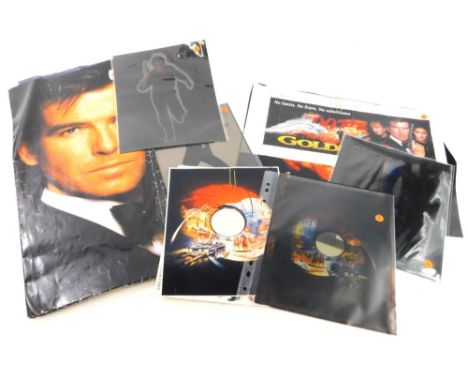 A collection of James Bond relating ephemera and display material, to include a poster of the film Golden Eye, a small advert