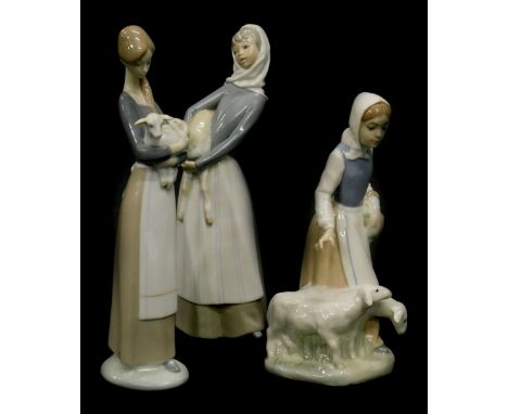A Spanish porcelain figure of a lady with sheep, and two similar Lladro figurines. (3)