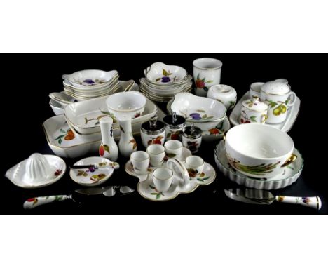 A large quantity of Royal Worcester Evesham serving dishes, egg cups, a chocolate sprinkler, etc.