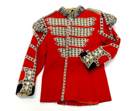 A vintage Coldstream Guards drummers tunic, in red with applied fleur de lys piping. 