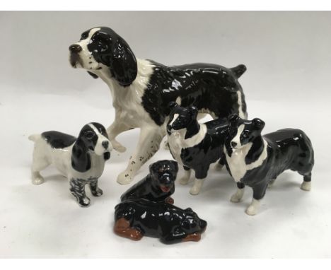 A collection of five ceramic dogs by Beswick and Royal Doulton.