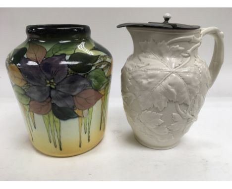 A Victorian ceramic jug decorated with leaves plus a decorative vase (2).