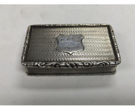 A Victorian snuff box with engine turned decoration and central cartouche, approx 7cm x 4cm x 1.5cm. Birmingham hallmarks.