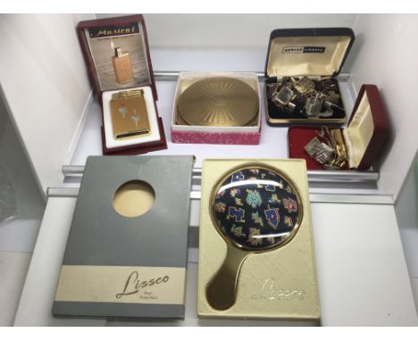 A group of lighters, compacts and cufflinks