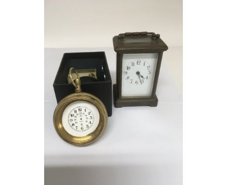 A brass carriage clock the enamel dial with Roman numerals and a bullseye watch for repair