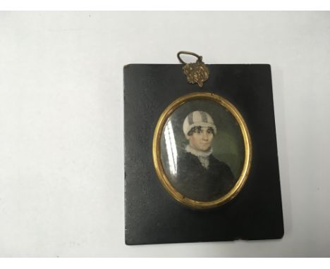 A framed watercolour miniature portrait of a young boy.